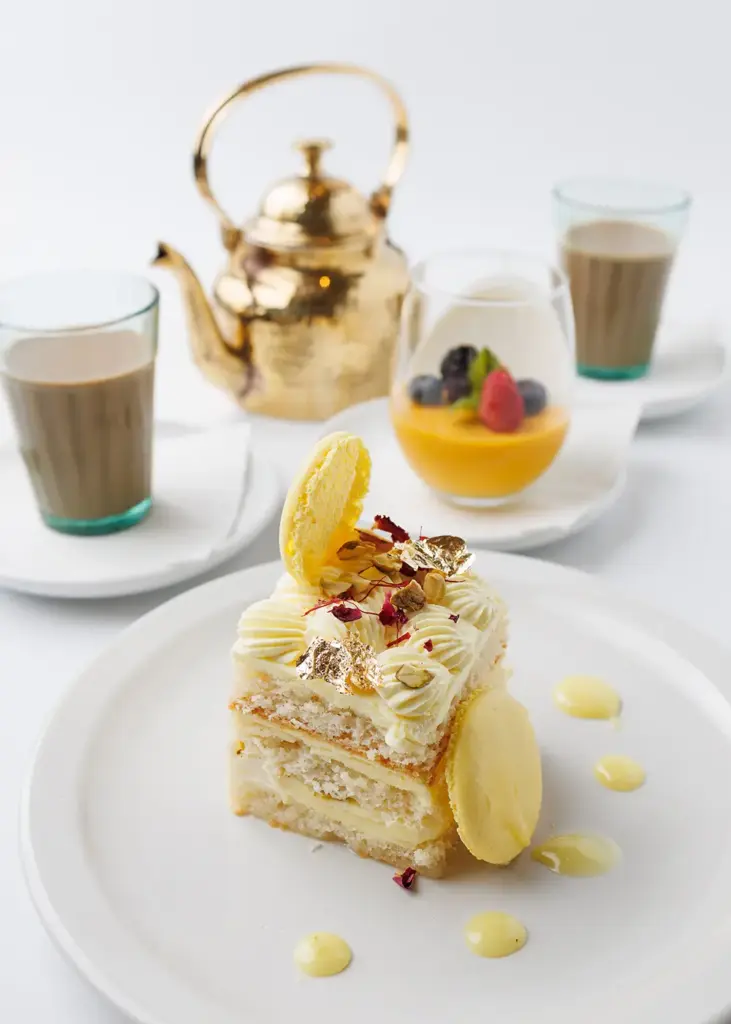 Indian-inspired dessert served with chai and a golden teapot at Central by Saffron Valley.