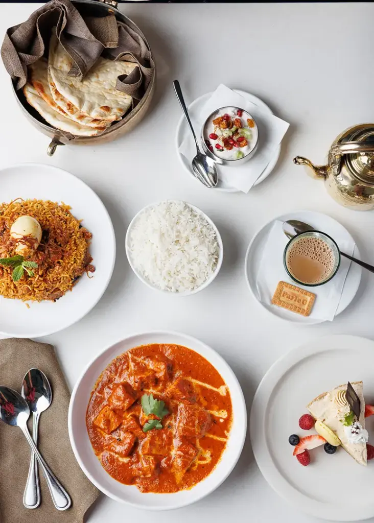 Indian food spread with curry, rice, naan, chai, and dessert at Central by Saffron Valley.