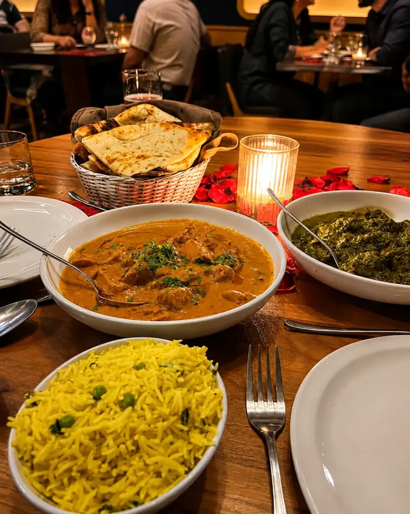 Fresh naan served with Indian curry during a dining experience at Central by Saffron Valley.