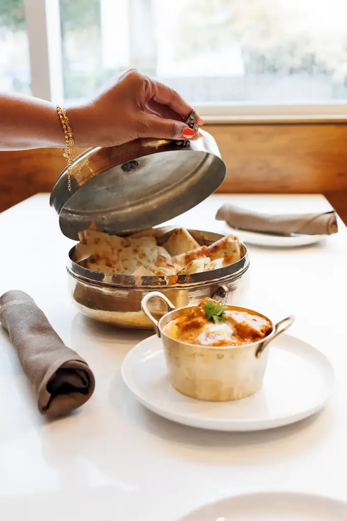 Fresh naan and Indian curry served during a private dining experience at Central by Saffron Valley.