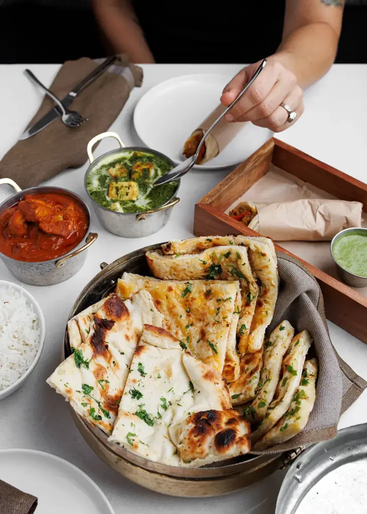 Fresh naan, Indian curries, rice, and shared dishes served at Central by Saffron Valley.